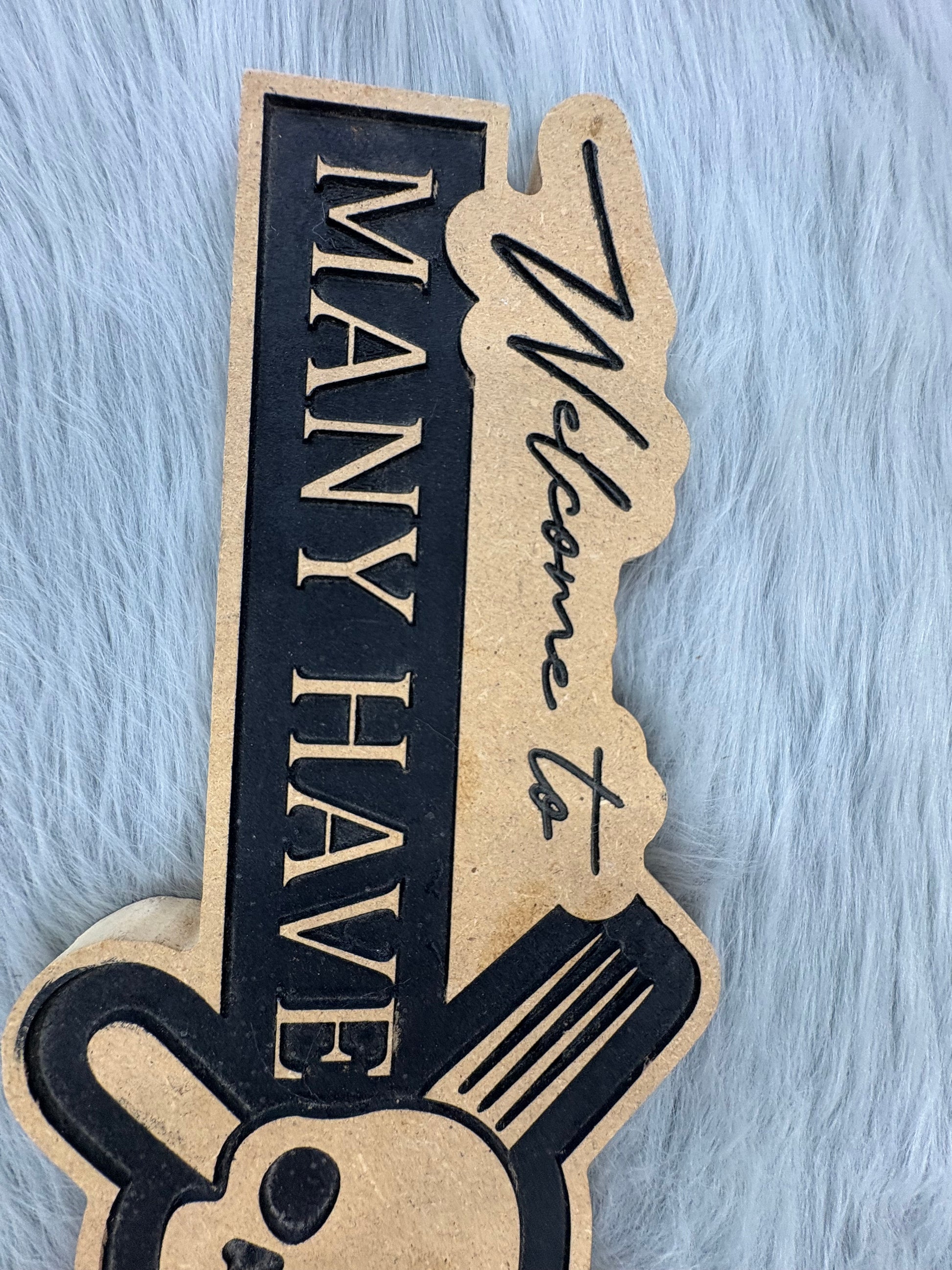 CNC Engraved Kitchen Sign – “Welcome to Our Kitchen: Many Have Eaten Here, Few Have Died” with Skull & Crossbones | Rustic Black & Wood Look | 9.5” x 16” | $30